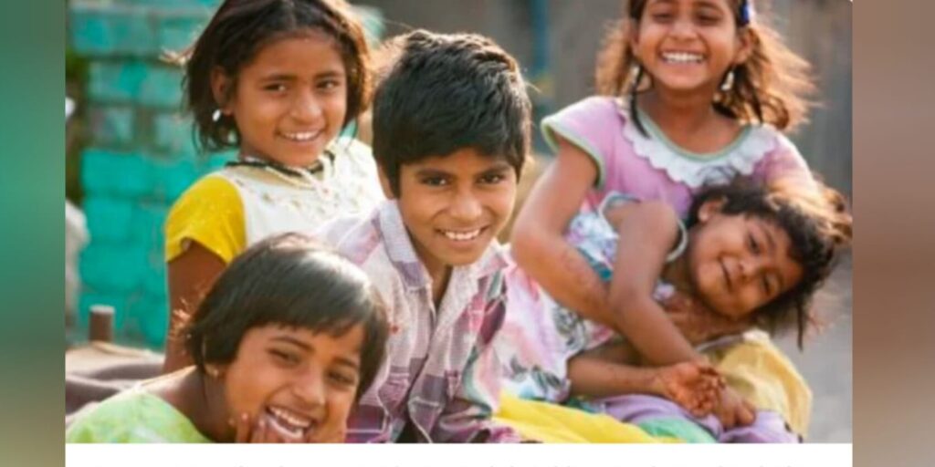 Image of children smiling and laughing at the camera